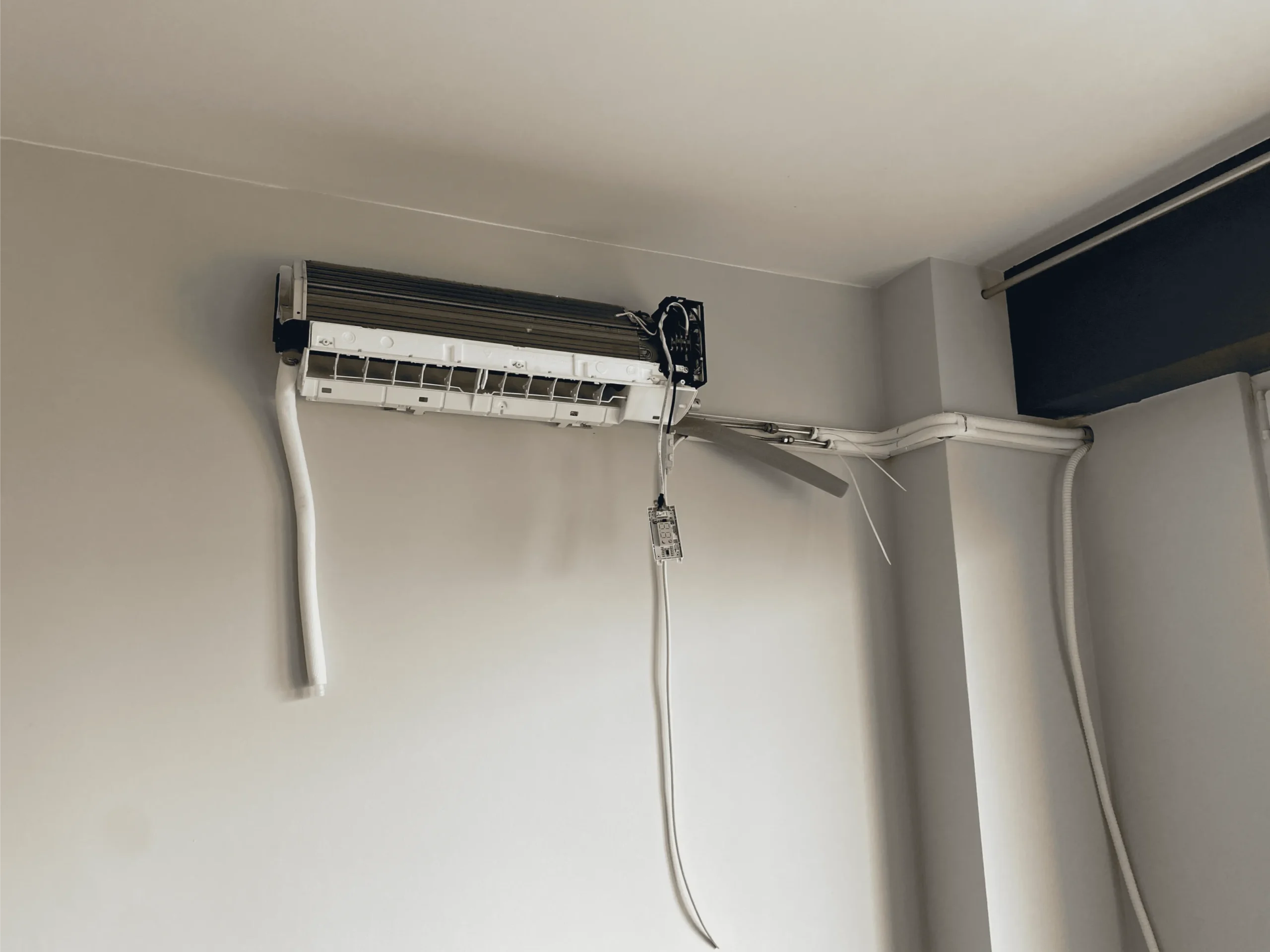 Widok wewnętrznej jednostki klimatyzacji ściennej z odsłoniętymi elementami podczas montażu